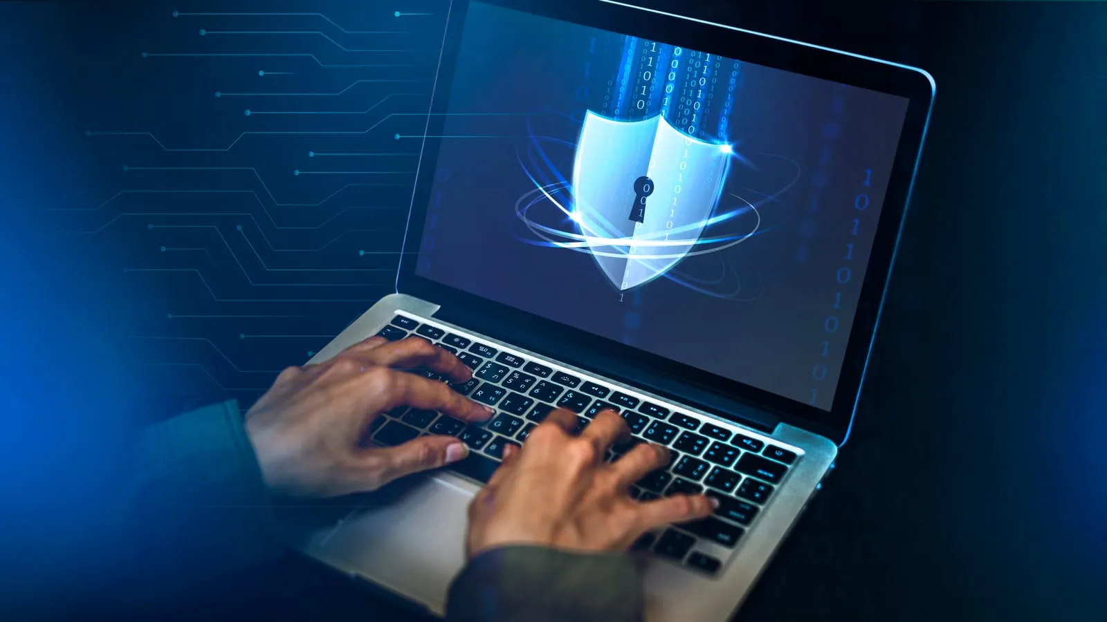 A glowing security shield on a laptop screen, representing threat protection