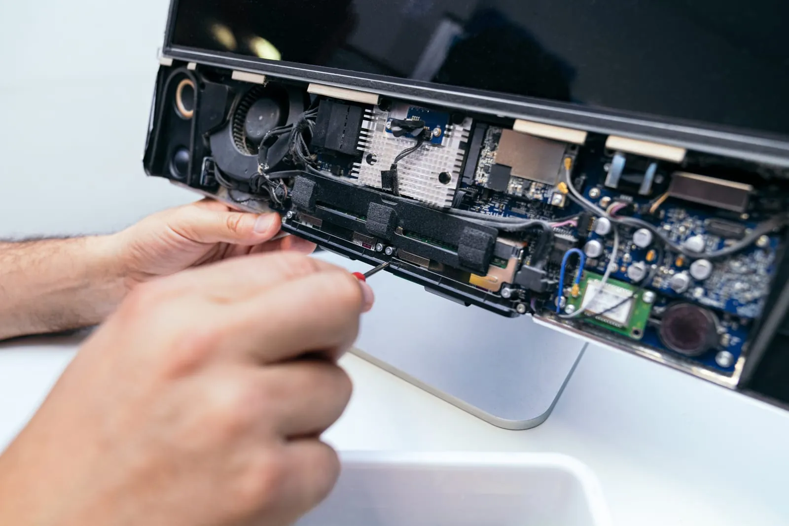 A 360 IT Support engineer repairing a computer at the workbench